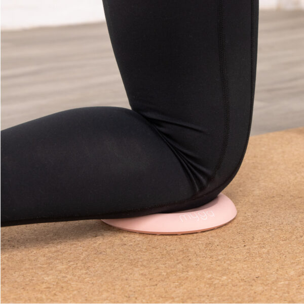 Pink Support pad being used on a cork yoga mat