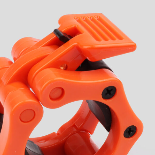 Close up of the orange phoenix fitness barbell collar, and it's sturdy quick release clip