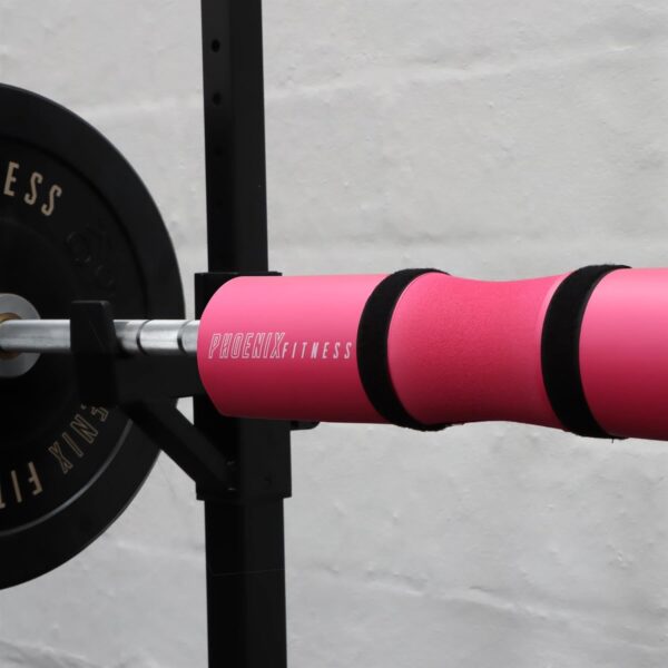 Pink Barbell pad in gym setting.