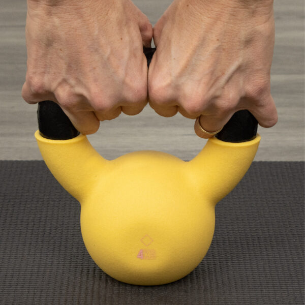 Image showing the size of the 4kg kettlebell in two hand grip