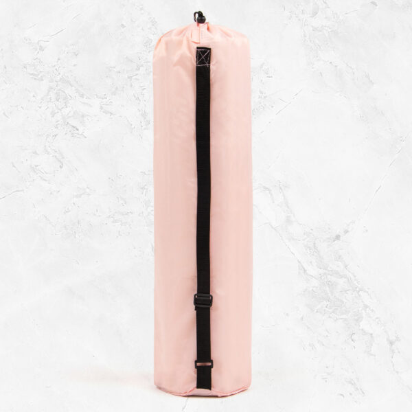 Pink yoga bag with black corded handle for over the shoulder use